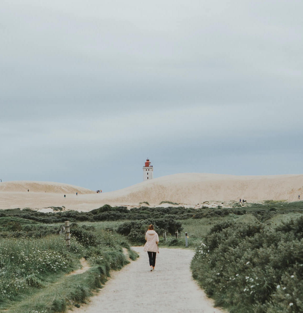 woman walking towards beach